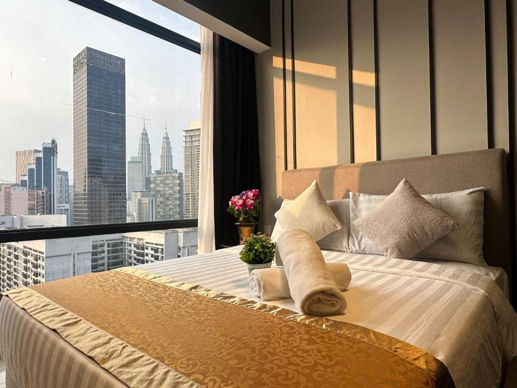 a bedroom with a bed with a view of a city at AXON Residence Kuala Lumpur in Kuala Lumpur