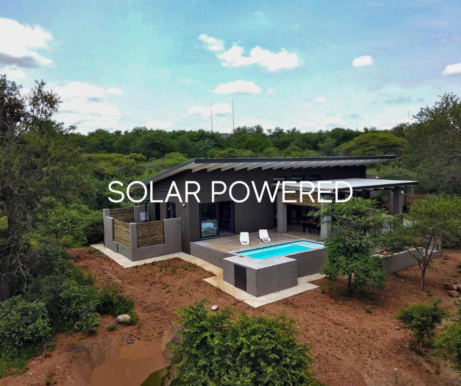 uma representação de uma casa movida a energia solar com uma piscina em Umkhaya em Marloth Park