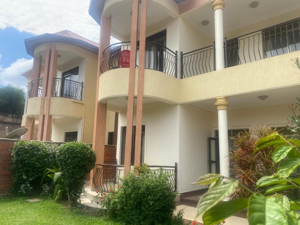 a large house with balconies on the side of it at ADRIEL HOMES WOODLAND CENTEr in Kigali