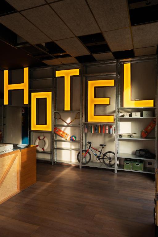 a room with yellow lights and bikes on the wall at Re Versiliana Hotel in Marina di Pietrasanta