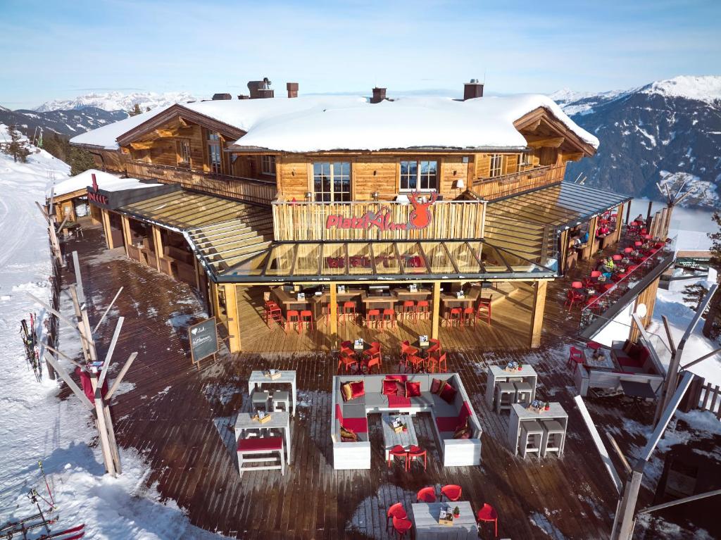 a house on top of a mountain in the snow at Berggasthof Platzlalm in Kaltenbach