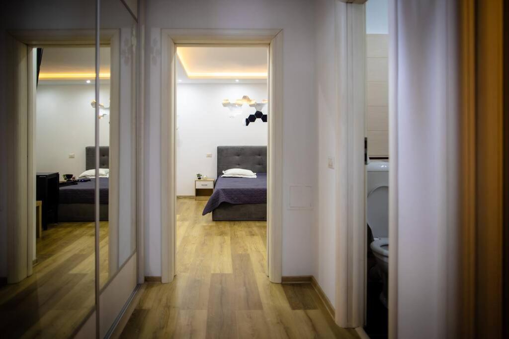a hallway with a room with a bed and a mirror at Nice place in Drumul Taberei in Bucharest