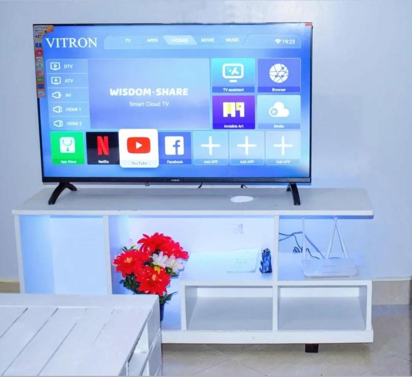 a flat screen tv sitting on top of a white table at Fully Furnished One Bedroom in Thika town31 in Thika
