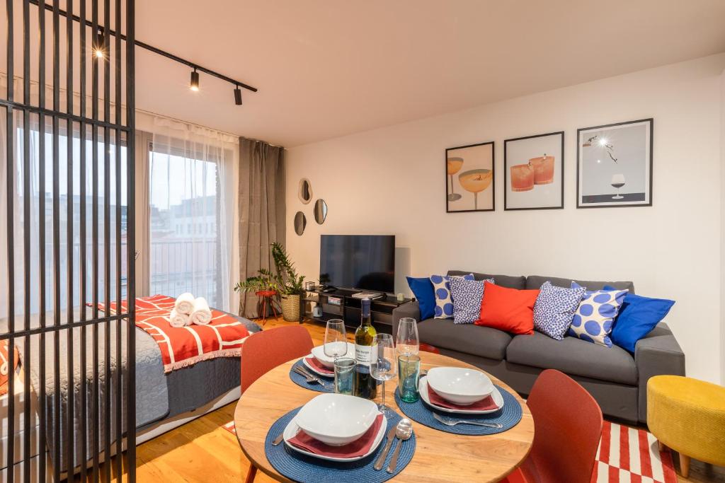 a living room with a couch and a table at Urban Chic Residences in Prague