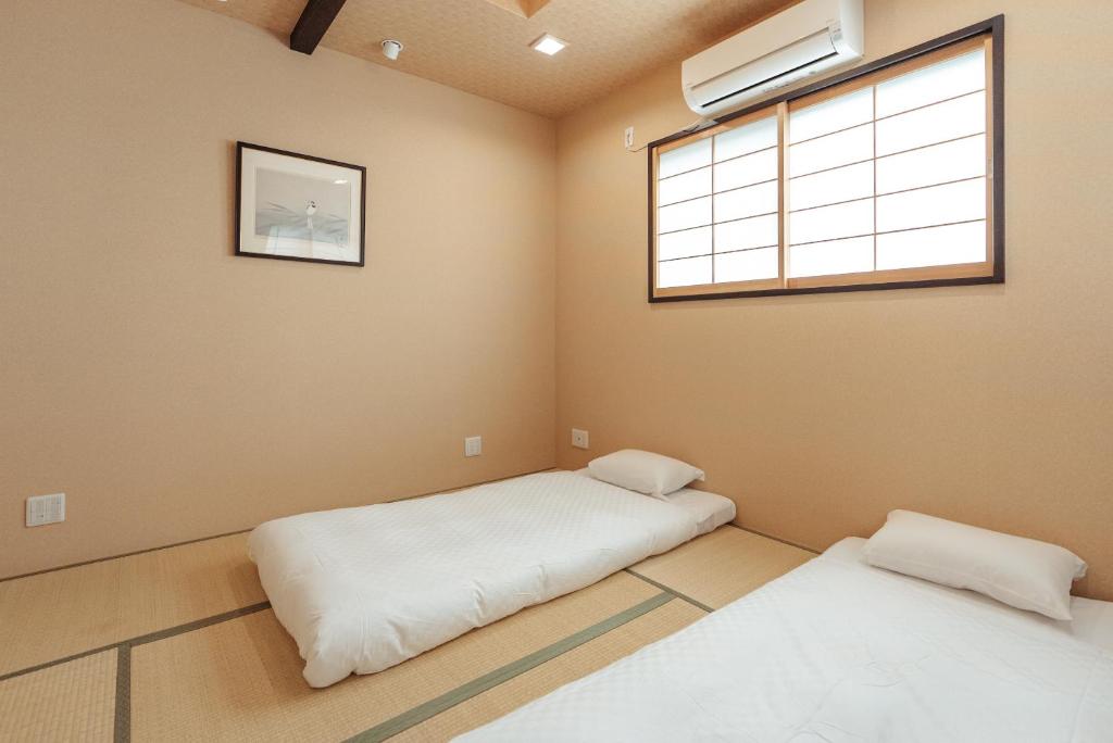 Postel nebo postele na pokoji v ubytování 谷町君 星屋 神泉ノ宿 二条城