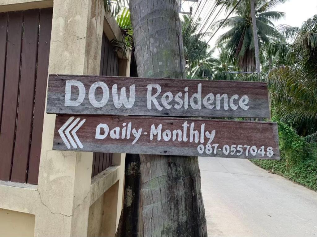 a sign on a palm tree that reads dow resilience k daily mortality at Dow Residance in Koh Samui 