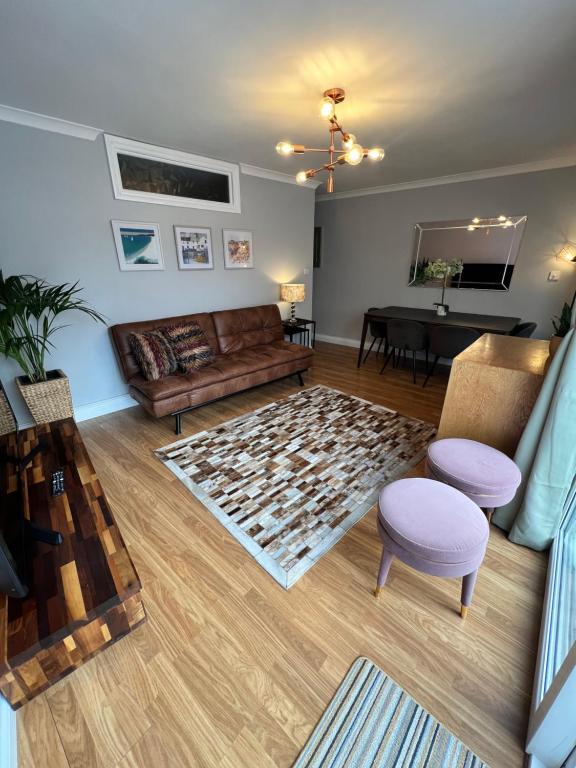 a living room with a couch and a table at Garden Place in Clevedon