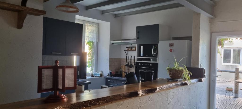 a kitchen with black cabinets and a counter top at Meublé de tourisme &quot;Les brosses tillots&quot; in Mary