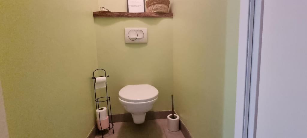 a bathroom with a white toilet in a room at Meublé de tourisme &quot;Les brosses tillots&quot; in Mary