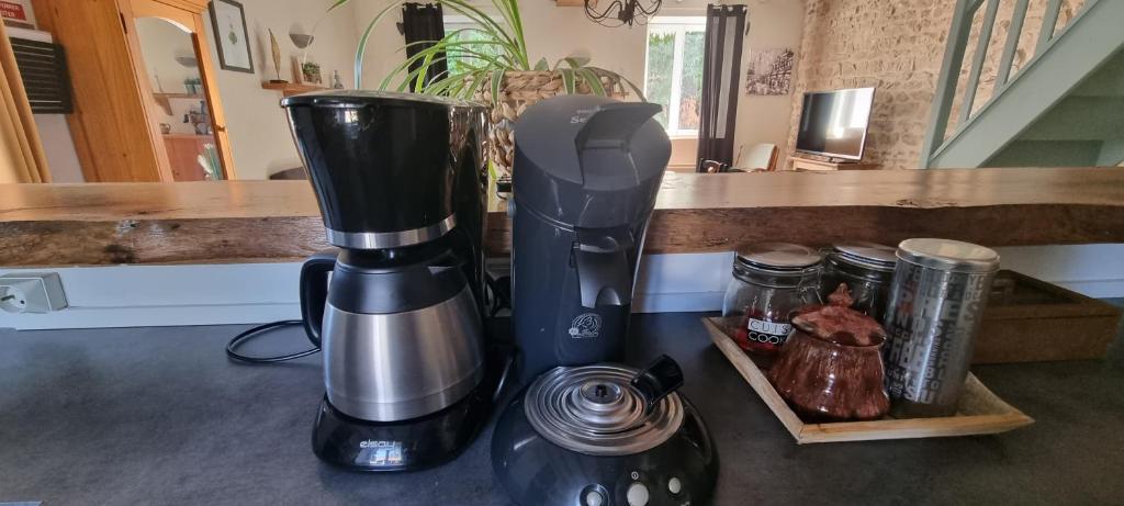 a coffeemaker sitting on a counter next to a coffee maker at Meublé de tourisme &quot;Les brosses tillots&quot; in Mary