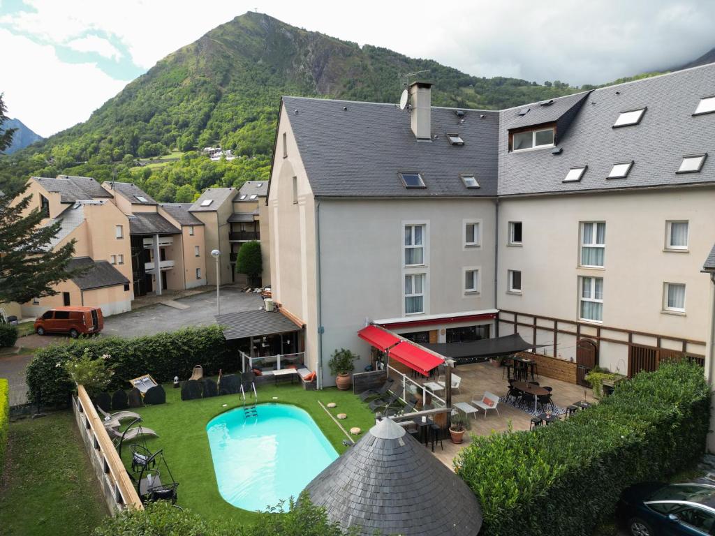 a view of the courtyard of a hotel with a swimming pool at Hôtel Les Arches in Saint-Lary-Soulan