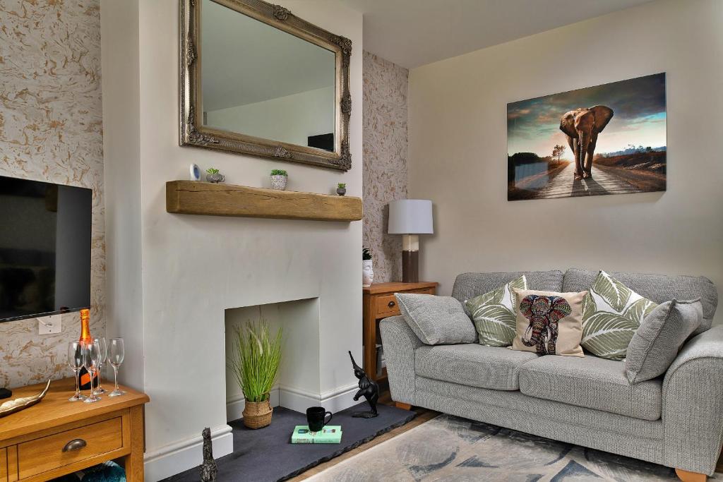 a living room with a couch and a fireplace at Finest Retreats - Shorelands in Prestatyn