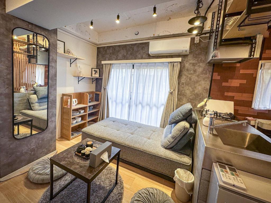 uma sala de estar com uma cama e um espelho em 桜の川2 Sugamo Diamond mansion 206 direct to Ikebukuro Yamanote line 5mins em Tóquio