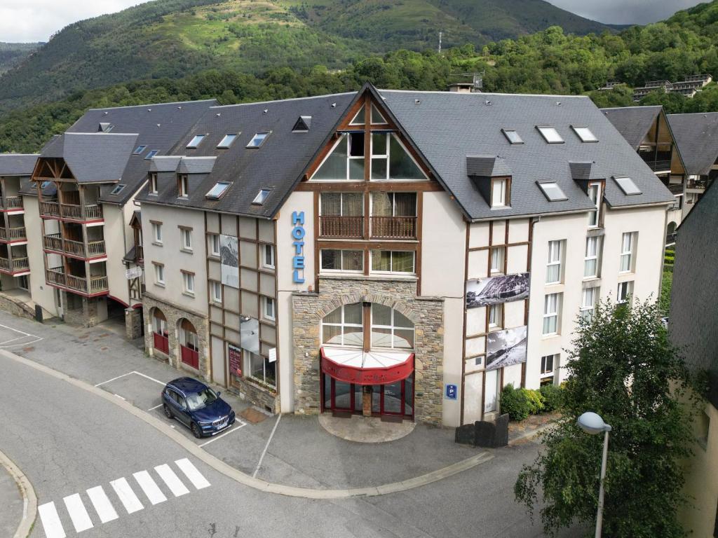 een appartementencomplex met een auto ervoor geparkeerd bij Résidence Les Arches in Saint-Lary-Soulan
