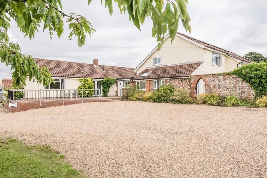 a house with a large driveway in front of it at Grove Farm Bungalow and Annexe in Woodbridge