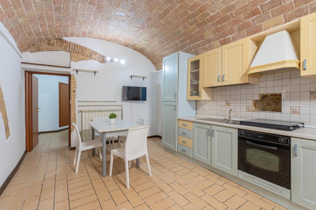 a kitchen with a table and a dining room at Leone Acciaioli - YourPlace Abruzzo in Ortona