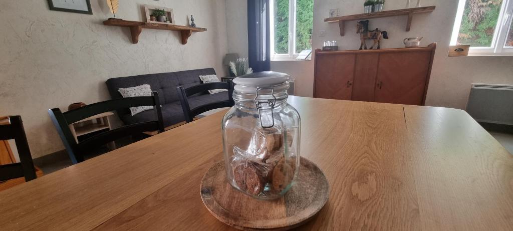 a glass jar with a fish in it sitting on a table at Meublé de tourisme &quot;Les brosses tillots&quot; in Mary