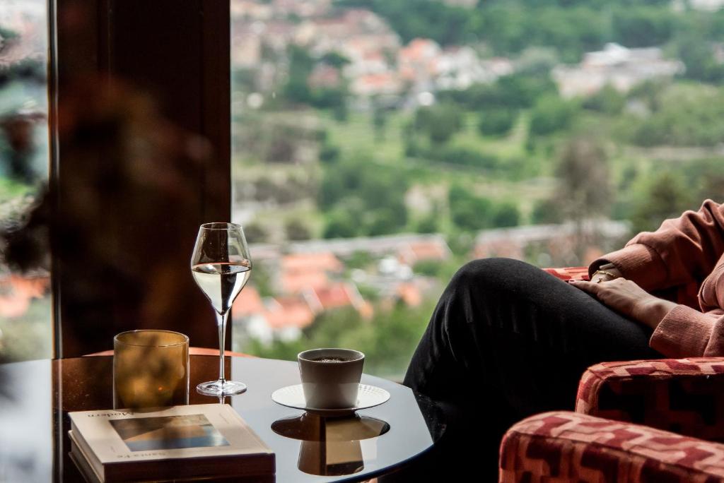 a person sitting at a table with a glass of wine at Billingehus in Skövde