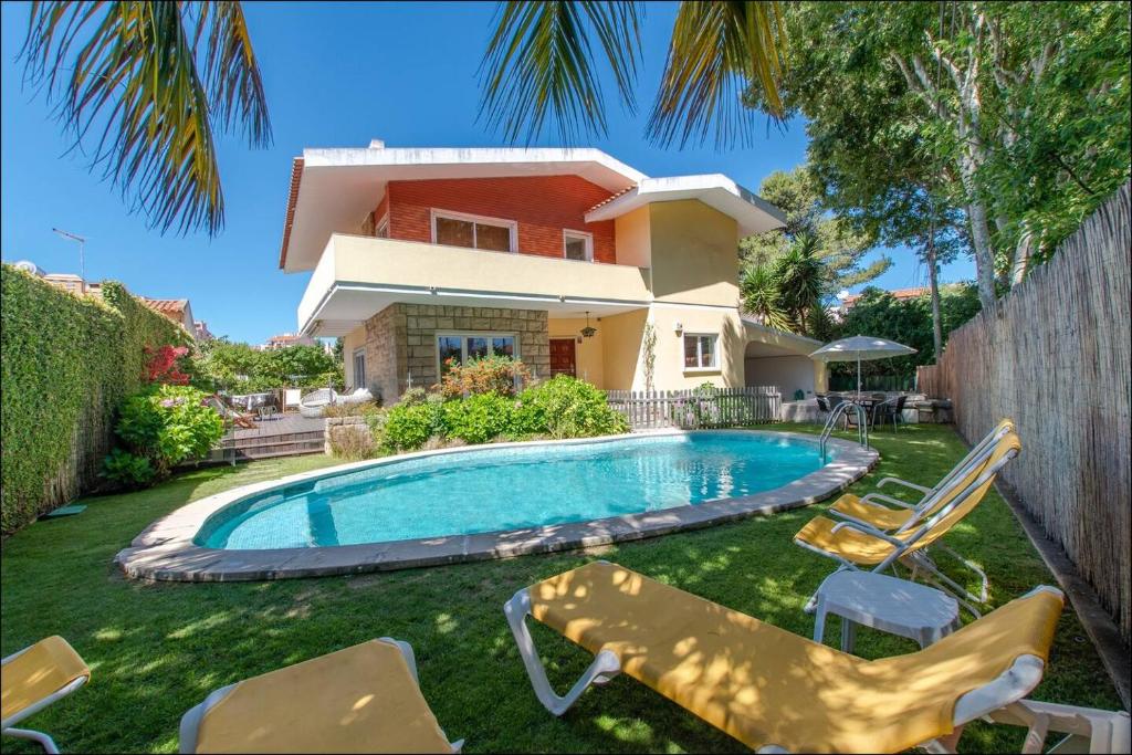 a house with a swimming pool in front of a house at Cascais Center Dream House in Cascais