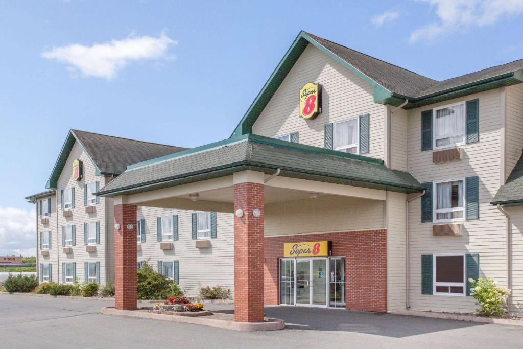 a hotel with a sign on the front of it at Super 8 by Wyndham Truro NS in Truro