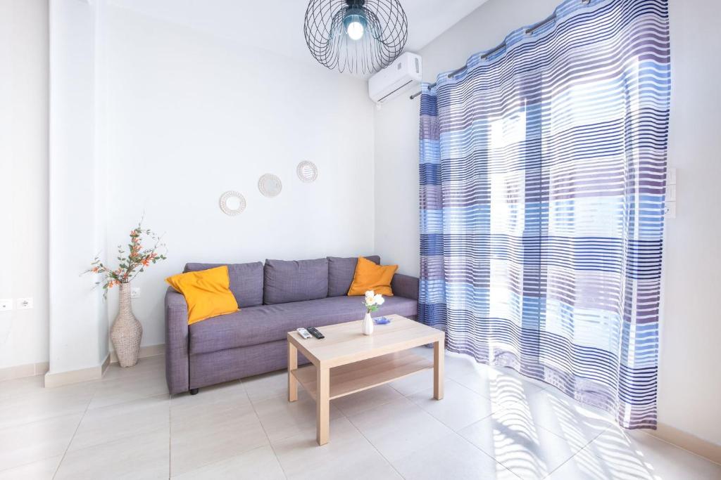 a living room with a couch and a table at Bright Apartment In Piraeus in Piraeus