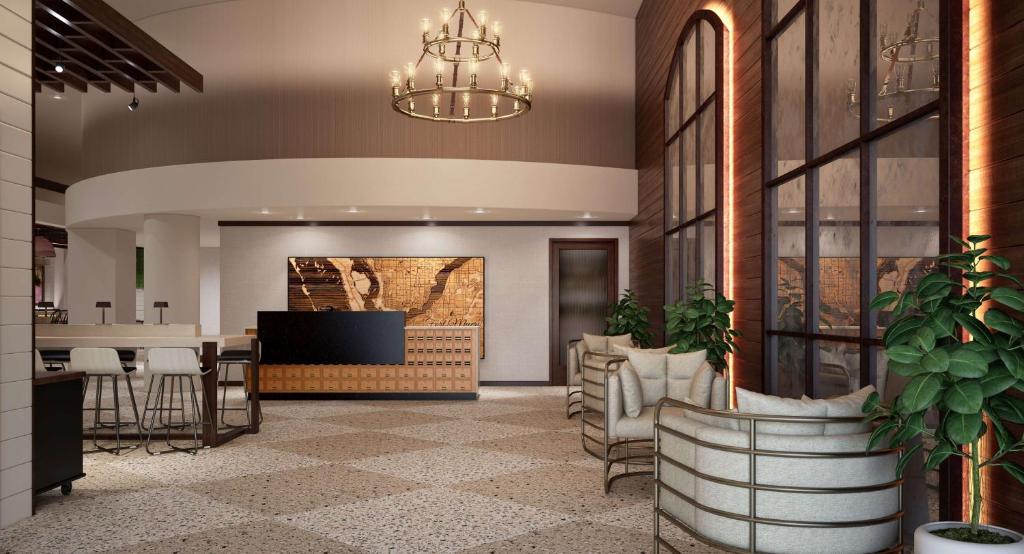 a lobby with a bar and a dining area at The Banyan Hotel Fort Myers, Tapestry Collection by Hilton in Fort Myers