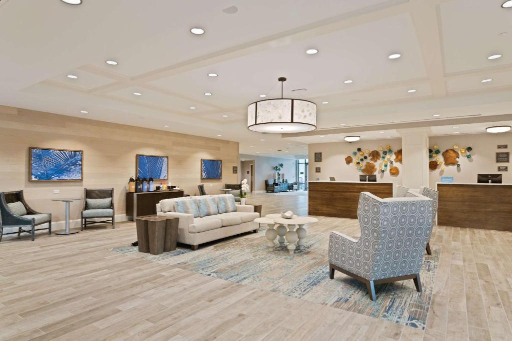 a lobby with a couch and chairs and a table at Homewood Suites By Hilton Panama City Beach, Fl in Panama City Beach