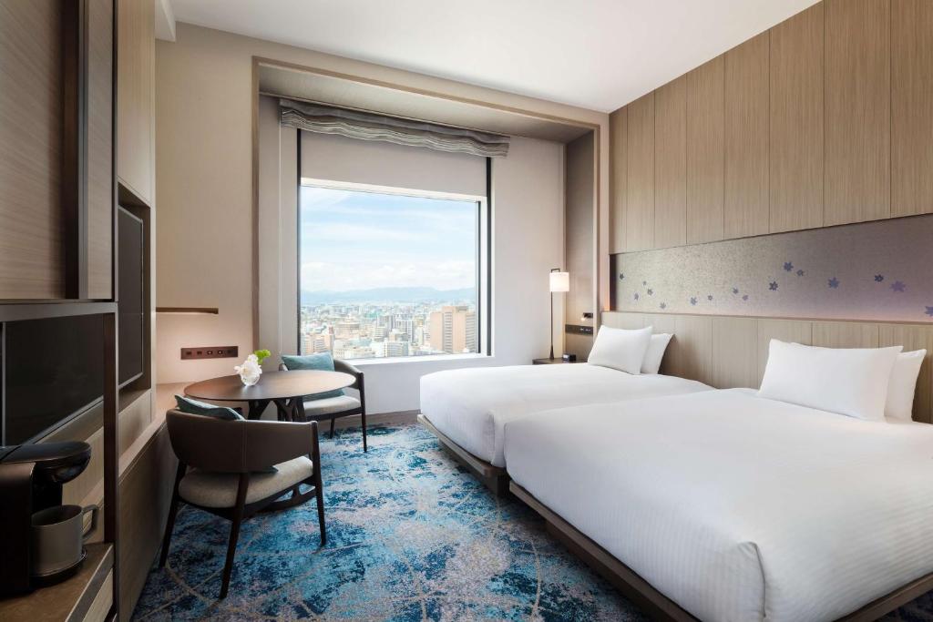 Postel nebo postele na pokoji v ubytování Hilton Hiroshima