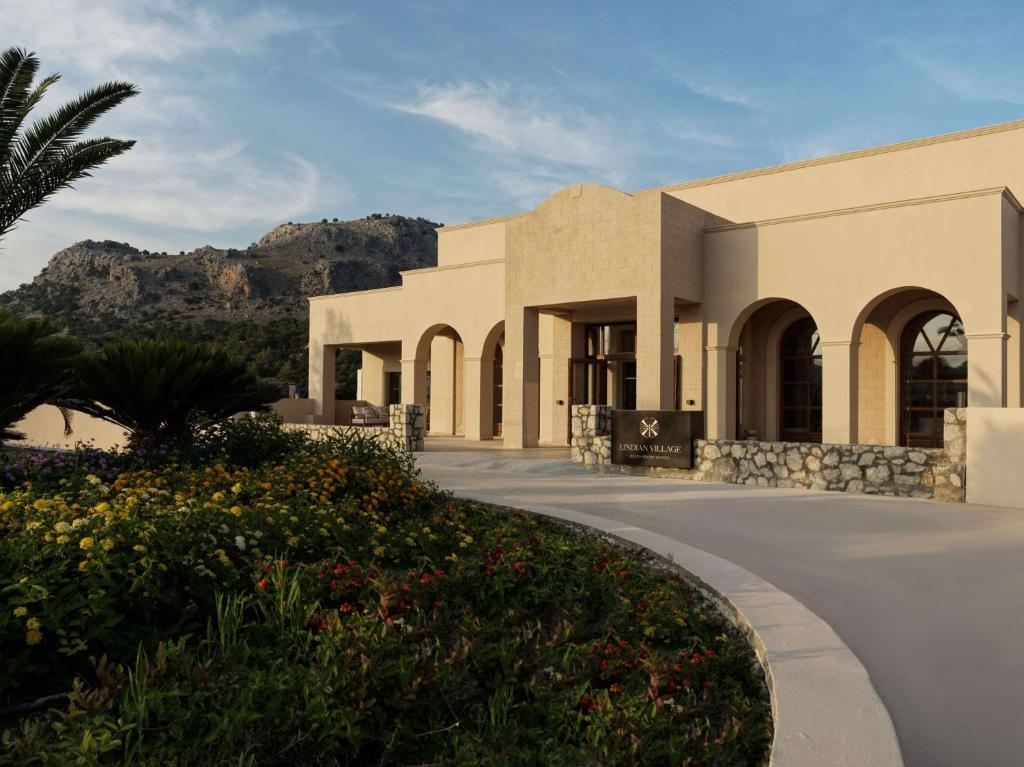 a rendering of a building with mountains in the background at Lindian Village Beach Resort, Curio Collection By Hilton in Kiotari