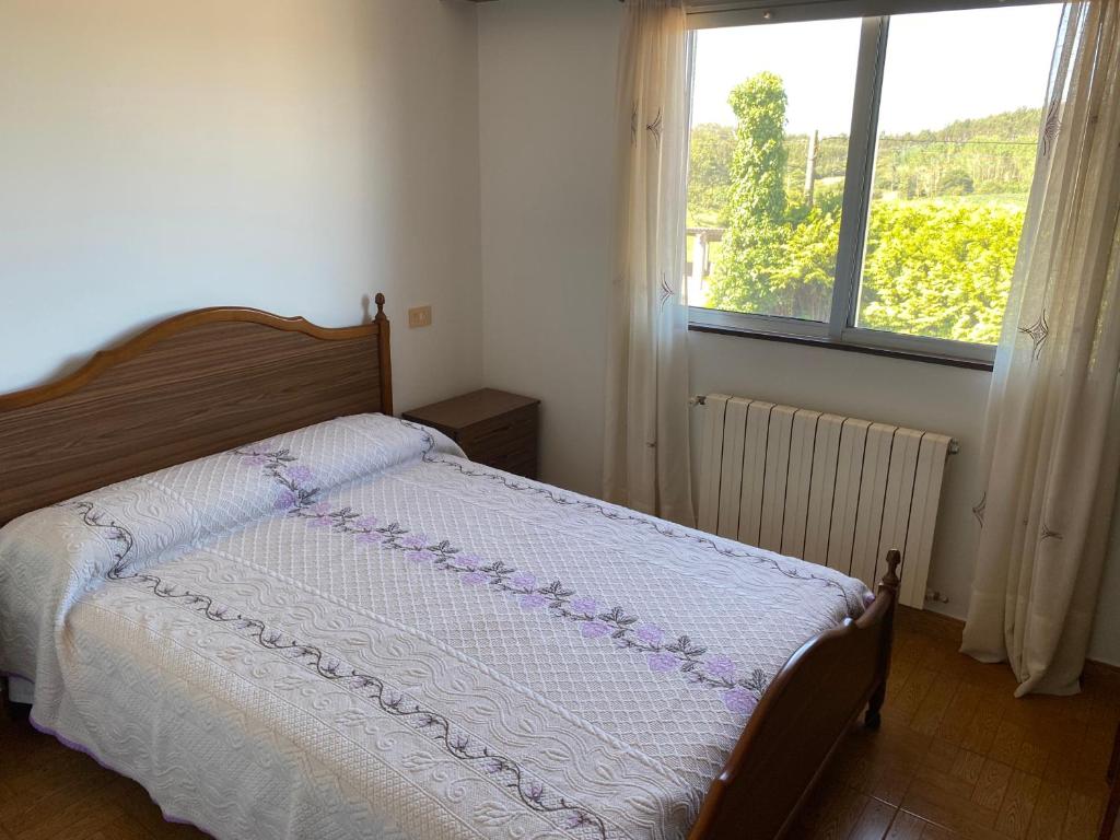 A bed or beds in a room at Casa Portomeiro