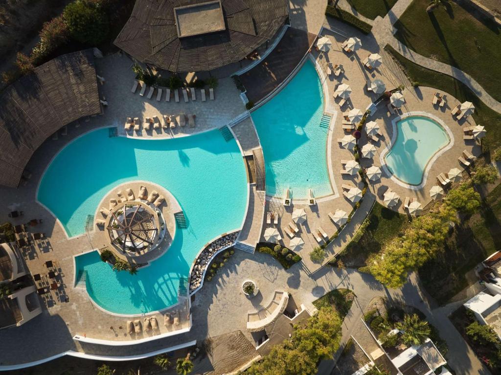 an overhead view of the pool at a resort at Lindian Village Beach Resort, Curio Collection By Hilton in Kiotari