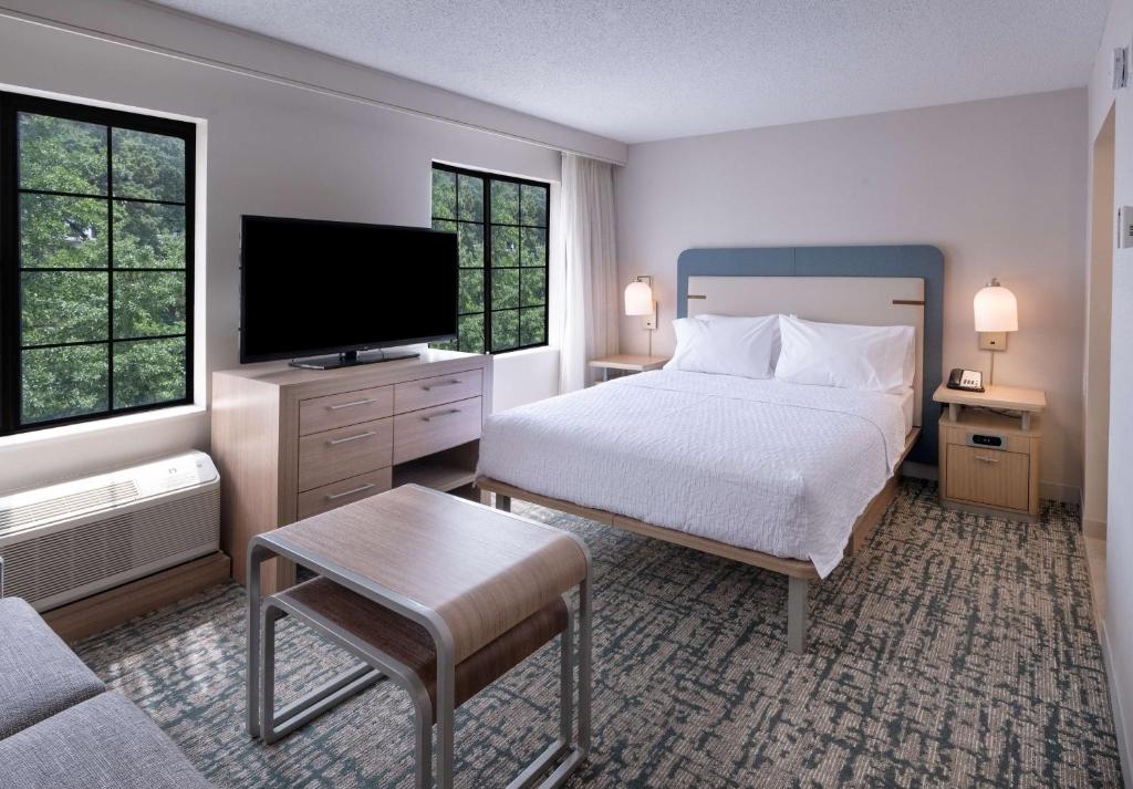 a bedroom with a bed and a flat screen tv at Homewood Suites by Hilton Atlanta Buckhead Pharr Road in Atlanta