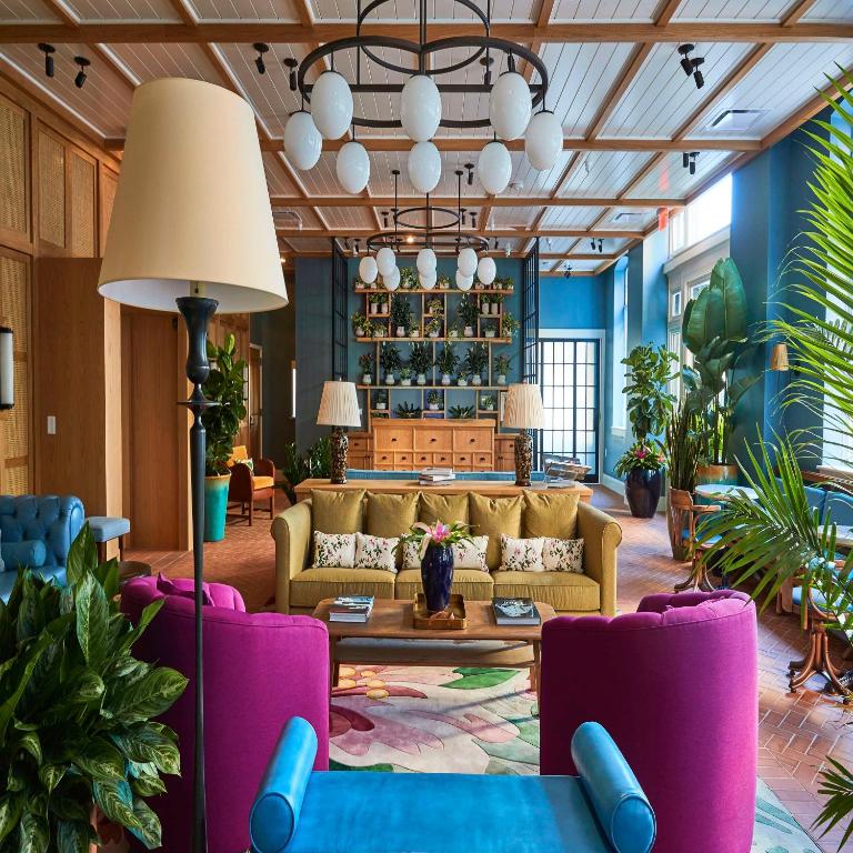 a living room with a couch and chairs at The Drayton Hotel Savannah, Curio Collection by Hilton in Savannah
