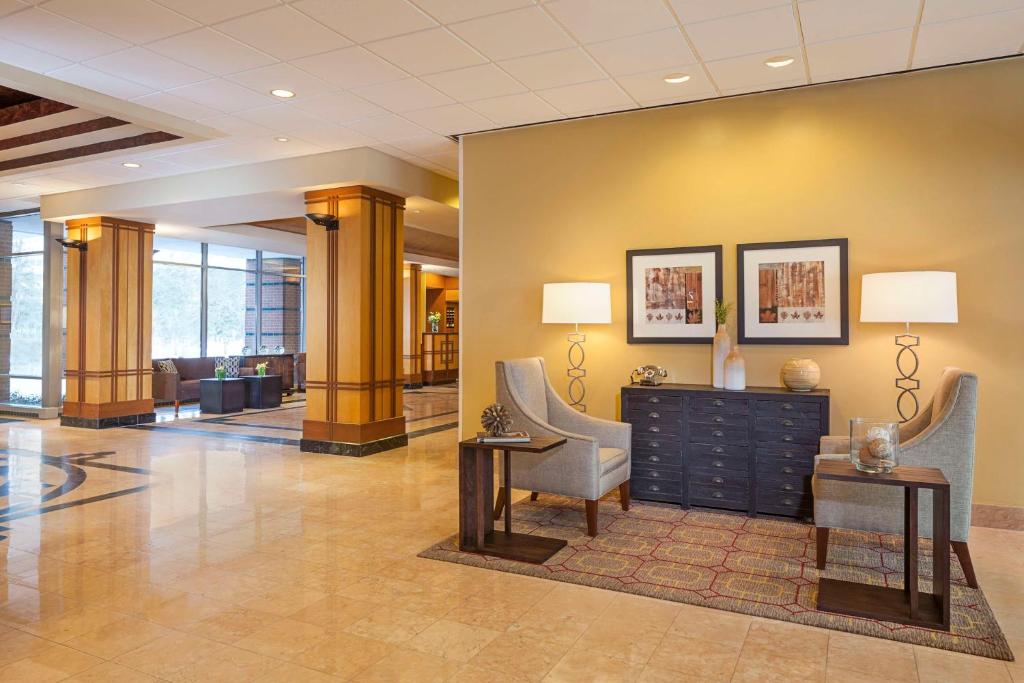 a lobby with two chairs and a desk in a building at Hampton Inn & Suites Downers Grove Chicago in Downers Grove