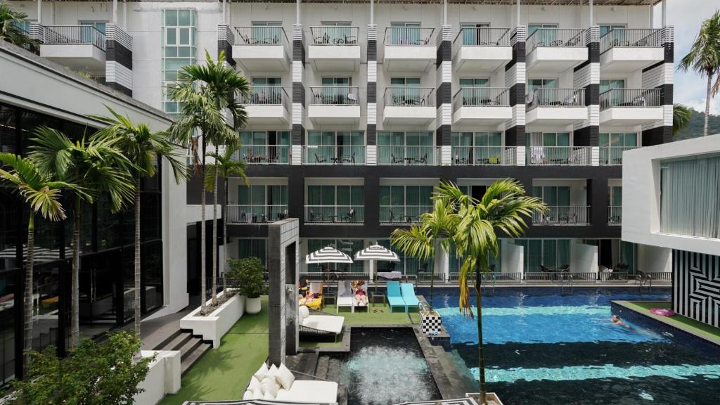 an external view of a hotel with a swimming pool at Sugar Marina Hotel - FASHION - Kata Beach - SHA Extra Plus in Kata Beach