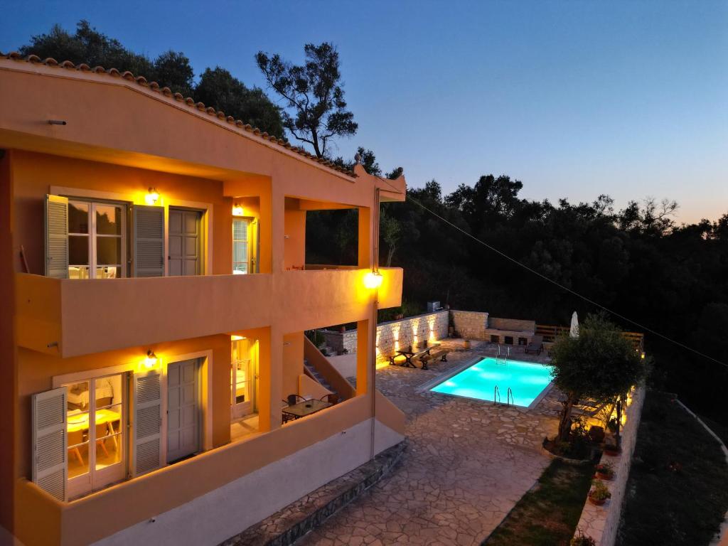 a view of a house with a swimming pool at Villa Kostas-NE Corfu with heated salt swimming pool in Agios Spyridon Corfu