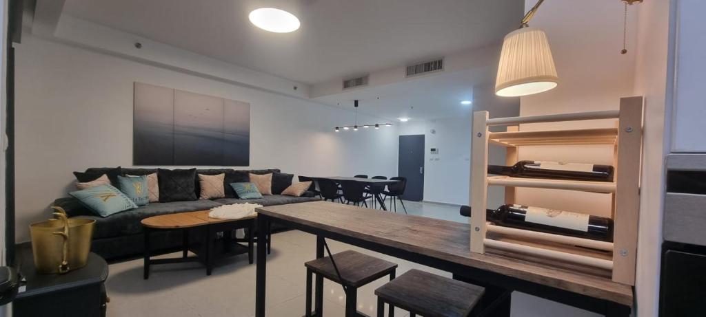 a living room with a couch and a table at Amazing apartment in Bat Yam