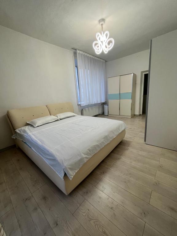 a bedroom with a large bed and a chandelier at Very central location 2 room (+kitchen toom) in Ulaanbaatar
