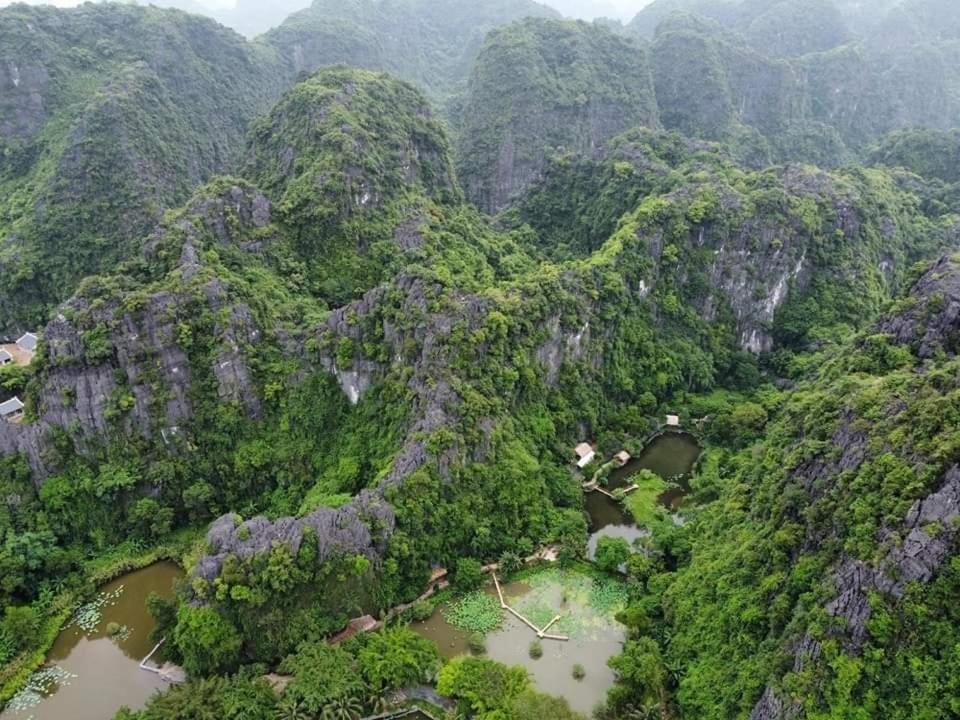 an aerial view of a mountain range with a river at Thung Sen Tam Coc Chalets in Ninh Binh