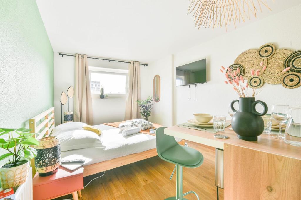 a bedroom with a bed and a desk at Parking - Le Studio - Tramway in Strasbourg