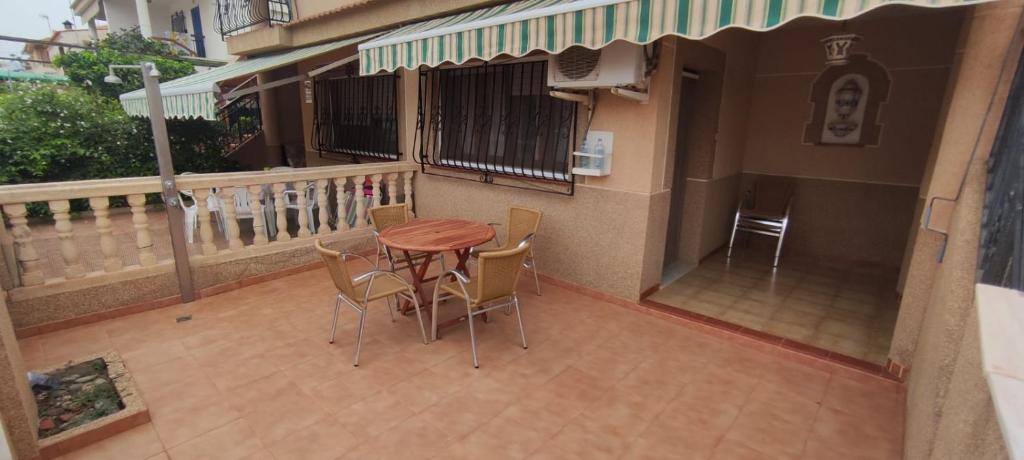 a patio with a table and chairs on a balcony at 28 Gaviotas in Calabardina
