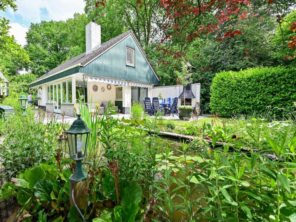 a house with a green roof in a garden at Holiday home in Overijssel with garden in Reutum