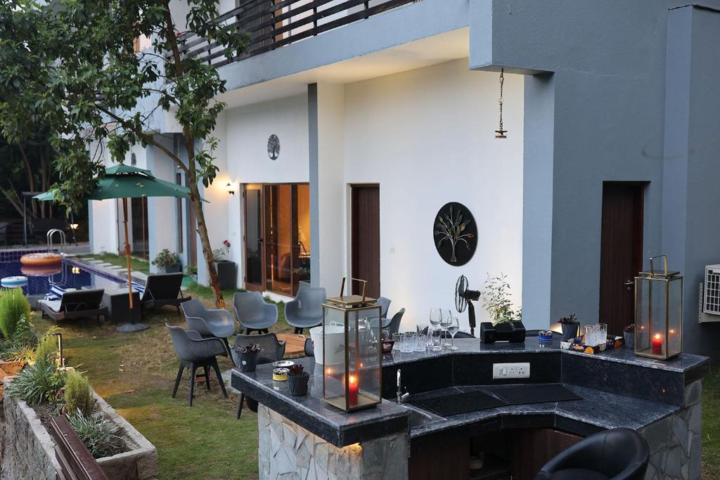 a house with a fireplace in a yard with chairs at villa 33 in Kasauli