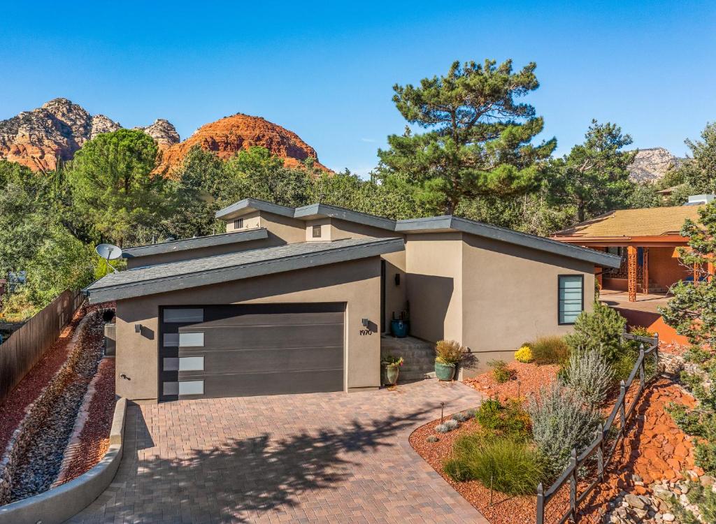 a house with a garage in front of a mountain at Modern Luxury Home in the Heart of West Sedona in Sedona