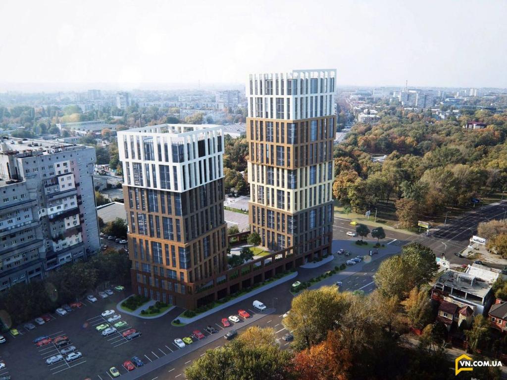 an aerial view of two tall buildings in a city at ApartPlus - Затишні апартаменти in Dnipro