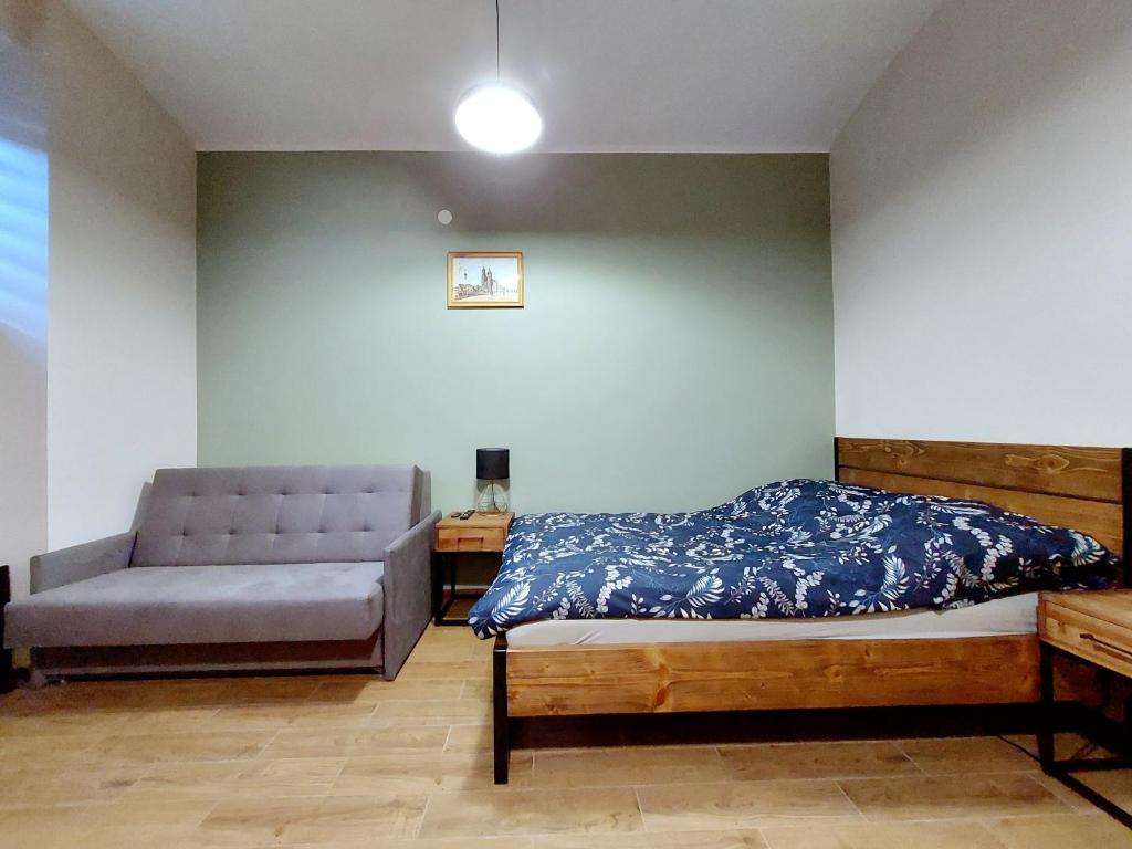 a bedroom with a bed and a couch at Krakowskim Szlakiem - OLD TOWN in Krakow