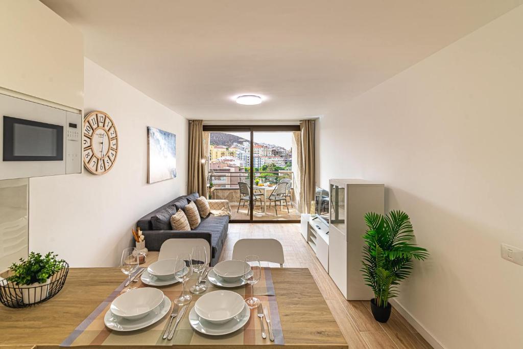 a living room with a table and a couch at Valdes Center Los Cristianos in Los Cristianos