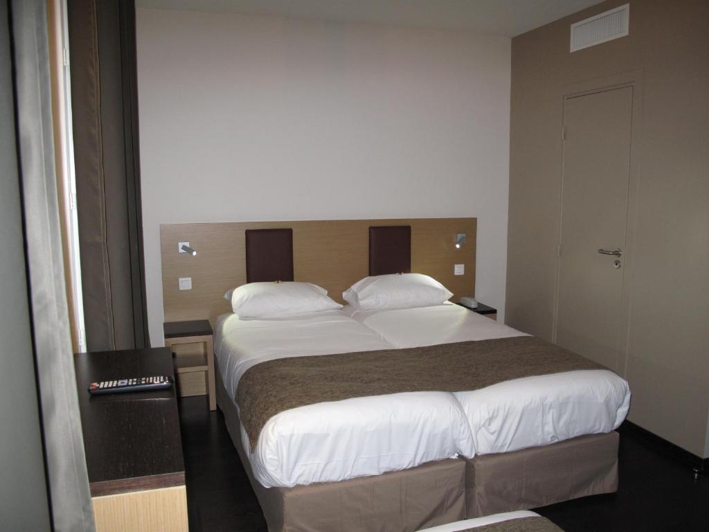 Voodi või voodid majutusasutuse Source Hôtel toas
