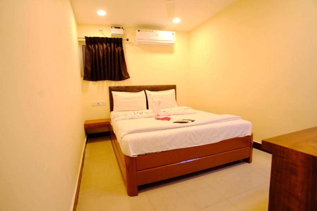 a small bedroom with a bed in a room at Bava Inn in Chennai
