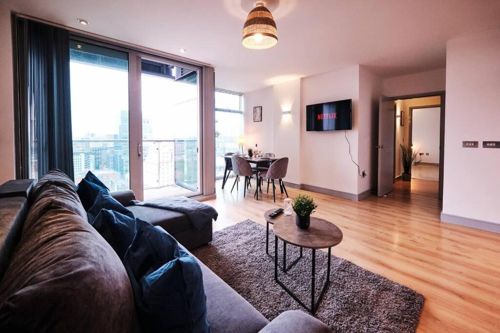 a living room with a couch and a table at Pluxa Nordic Sky - Spacious Manchester Gem 2Bed 2bath, & free parking in Manchester